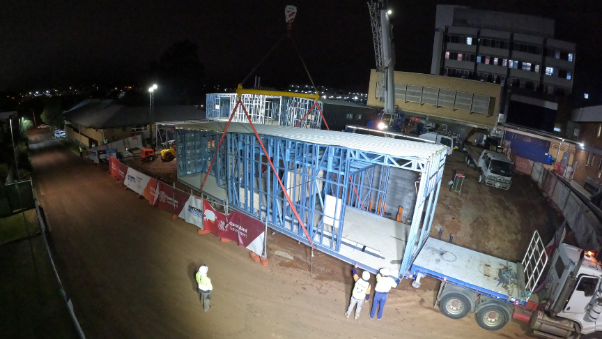 Crane lowering modular building at Toowoomba Hospital for emergency department expansion