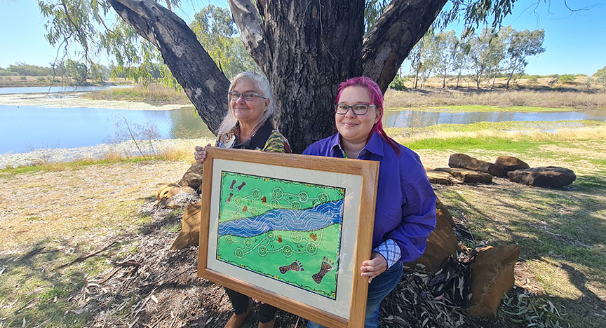 Tambo artists and Bidjara women Aunty Ann Russell and daughter Deann Frousheger with their artwork Coming Together on the banks of the Tambo Dam.