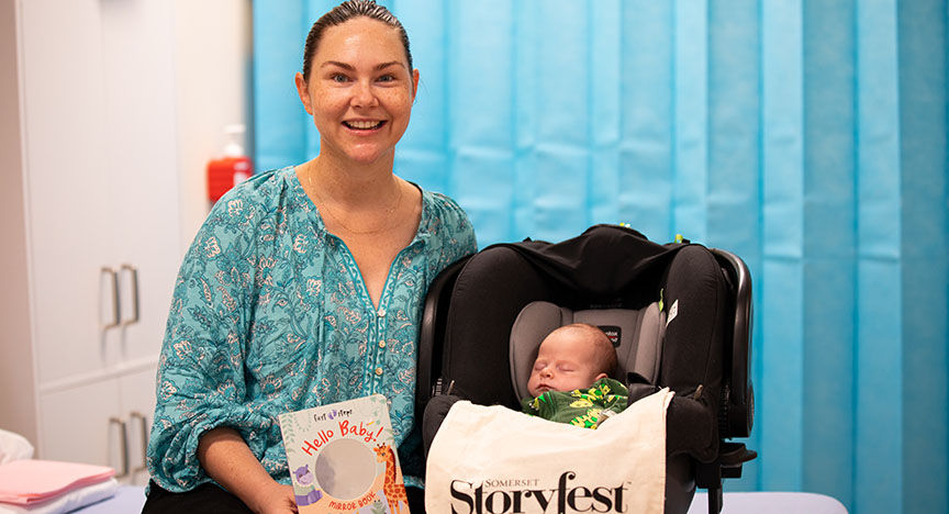 Mum Nina Groves and baby Hudson were happy to receive their Storyfest tote bag reading pack